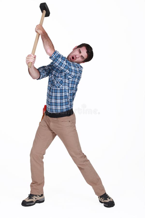 Man using a sledge-hammer. Man using a sledge-hammer
