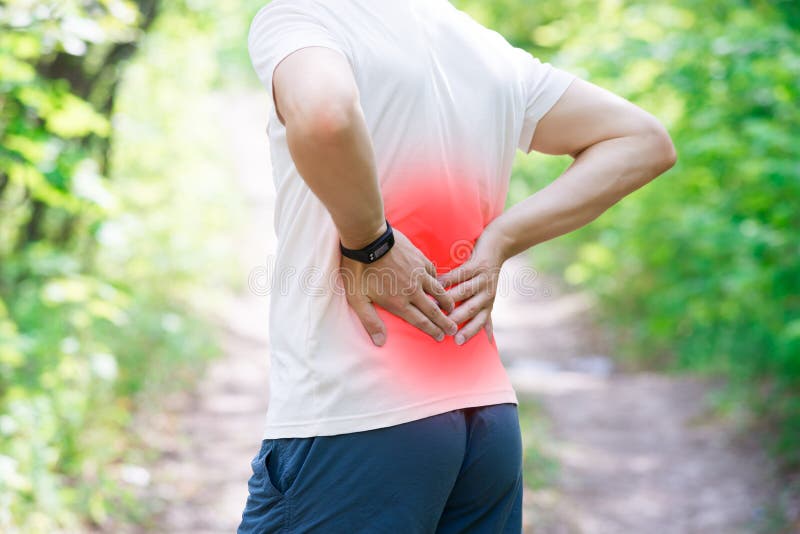 Man with back pain, injury while running, trauma during workout, outdoors concept. Man with back pain, injury while running, trauma during workout, outdoors concept