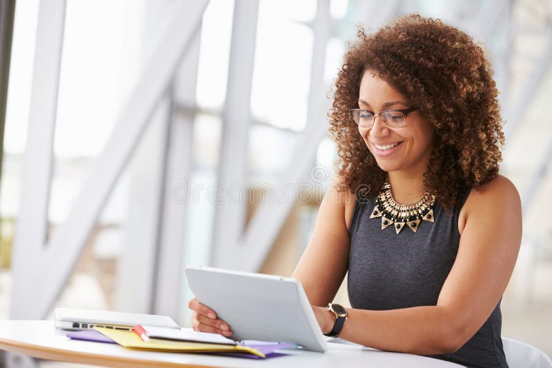 Young African American women working with tablet in office. Young African American women working with tablet in office