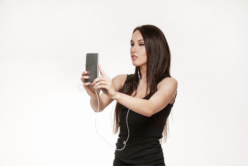 Young woman taking selfie after workout at the gym. Good looking brunette woman in sports outfit. Healthy lifestyle concept. Young woman taking selfie after workout at the gym. Good looking brunette woman in sports outfit. Healthy lifestyle concept.