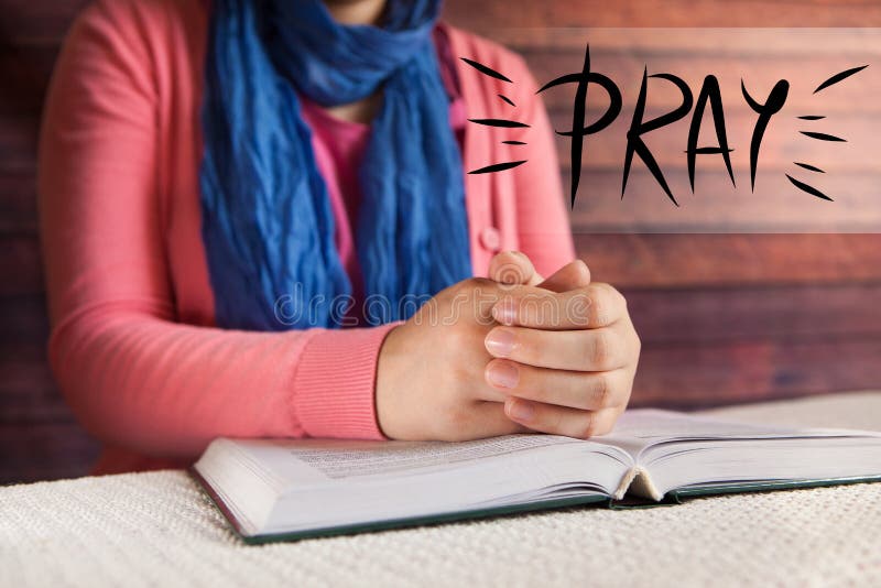 Young woman reading Bible and praying, religion and christianity concept with word pray. Young woman reading Bible and praying, religion and christianity concept with word pray