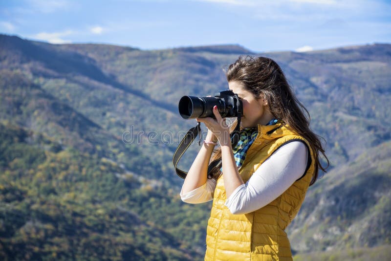 Młoda kobieta fotograf bierze fotografię piękna góra obrazy stock Młoda kobieta fotograf bierze fotografię piękna góra obrazy stock
