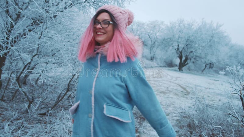Młoda szczęśliwa kobieta chodząca zimą lasy przyrodnicze cieszy się pięknymi, mroźnymi drzewami lodu śnieżnego. modelka moda dziew zdjęcie wideo