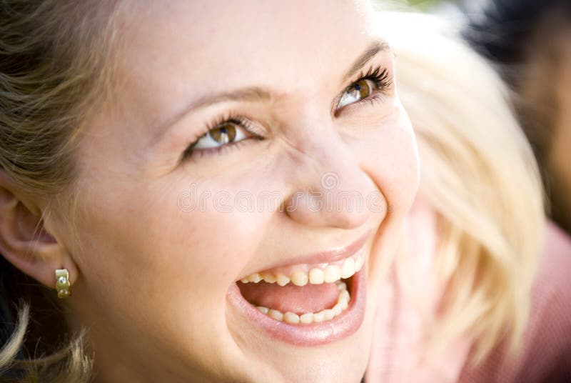 Young woman looking up and laughing. Young woman looking up and laughing.