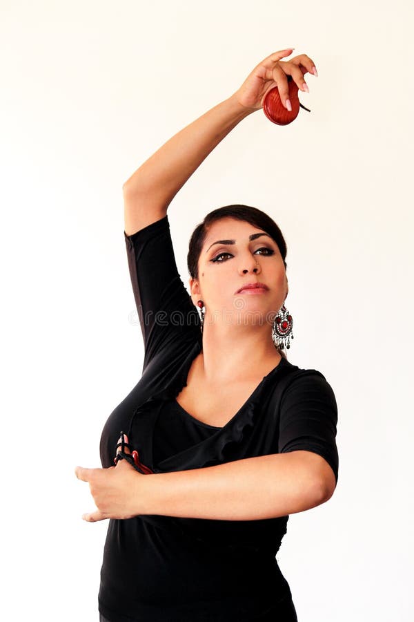 Młodej Hiszpańskiej cygańskiej kobiety dancingowy flamenco z brown kastanietami zdjęcie stock Młodej Hiszpańskiej cygańskiej kobiety dancingowy flamenco z brown kastanietami zdjęcie stock