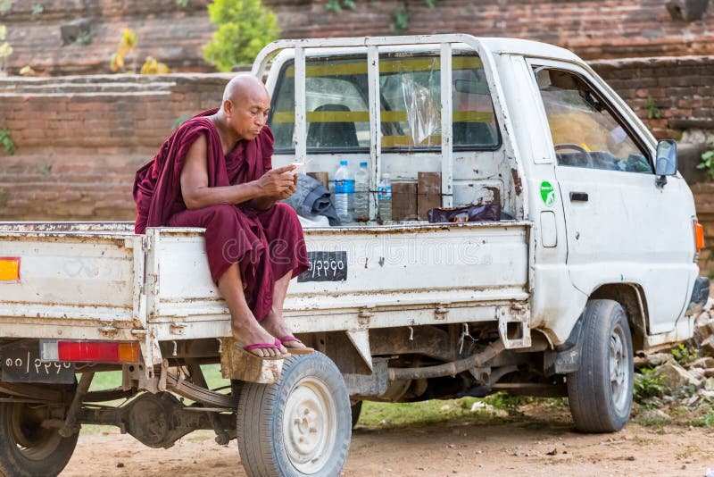 MANDALAY, MYANMAR - NOVEMBER 24, 2014: monk in Mingun, near Mandalay, in Myanmar. MANDALAY, MYANMAR - NOVEMBER 24, 2014: monk in Mingun, near Mandalay, in Myanmar