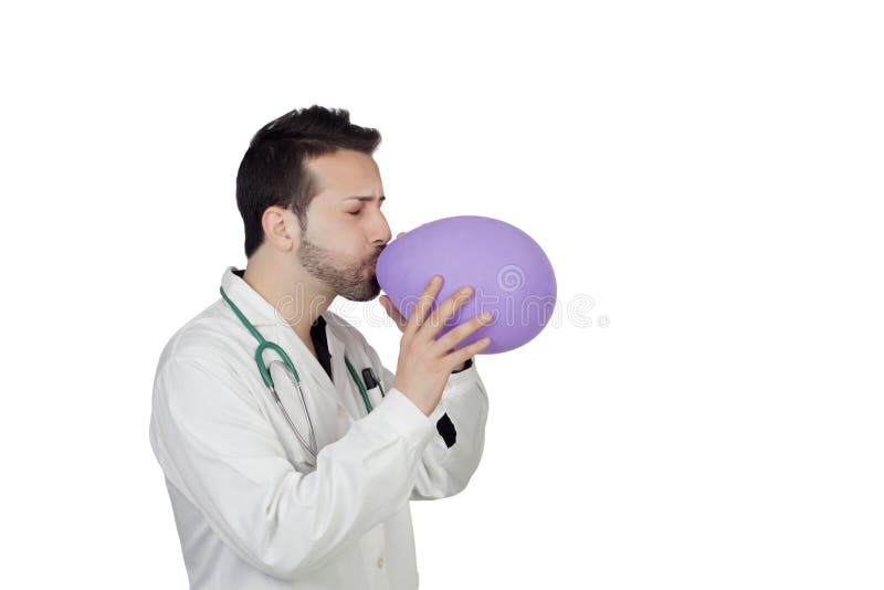 Młody samiec lekarki dmuchania balon zdjęcia stock Młody samiec lekarki dmuchania balon zdjęcia stock
