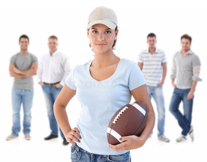 Group of happy young people, smiling woman at front holding football, isolated on white background. Group of happy young people, smiling woman at front holding football, isolated on white background.