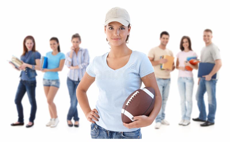 Group of happy young people, smiling women at front holding football, isolated on white background. Group of happy young people, smiling women at front holding football, isolated on white background.