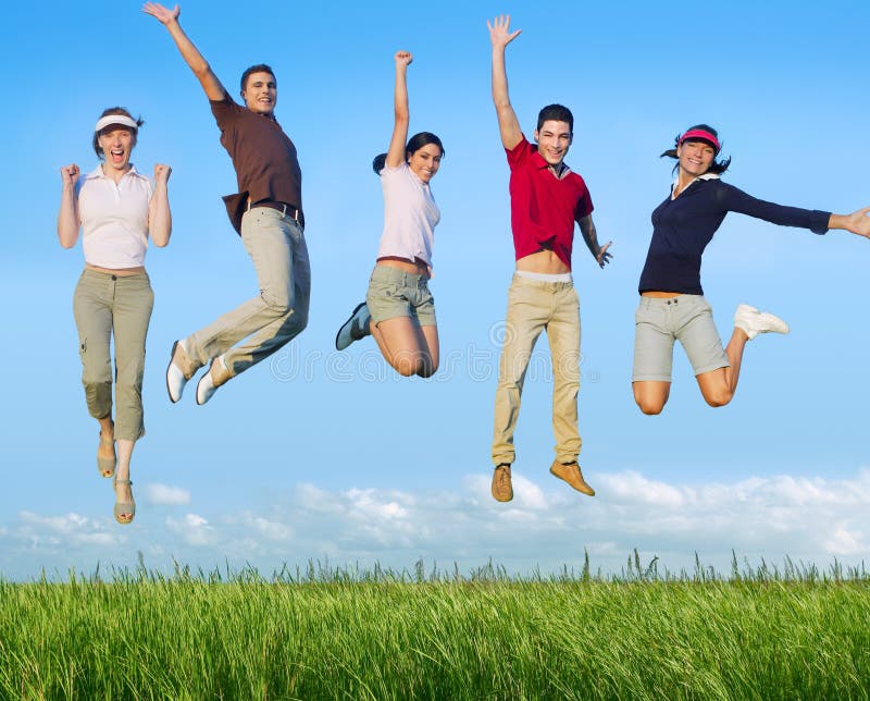 Jumping young people happy group in meadow blue sky outdoor. Jumping young people happy group in meadow blue sky outdoor