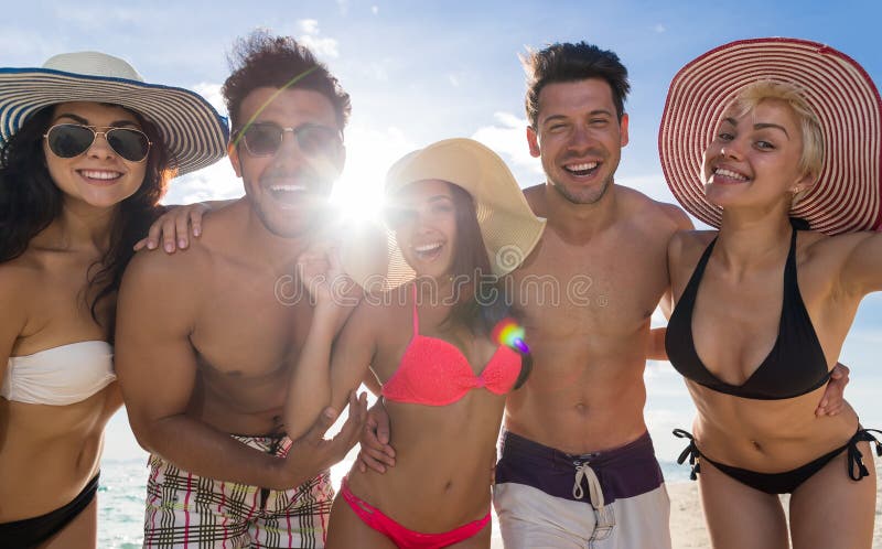 Young People Group On Beach Summer Vacation, Happy Smiling Friends Closeup Seaside Sea Ocean Holiday Travel. Young People Group On Beach Summer Vacation, Happy Smiling Friends Closeup Seaside Sea Ocean Holiday Travel