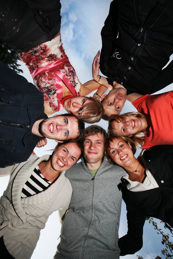 Group of happy young people in circle outdoors. Group of happy young people in circle outdoors