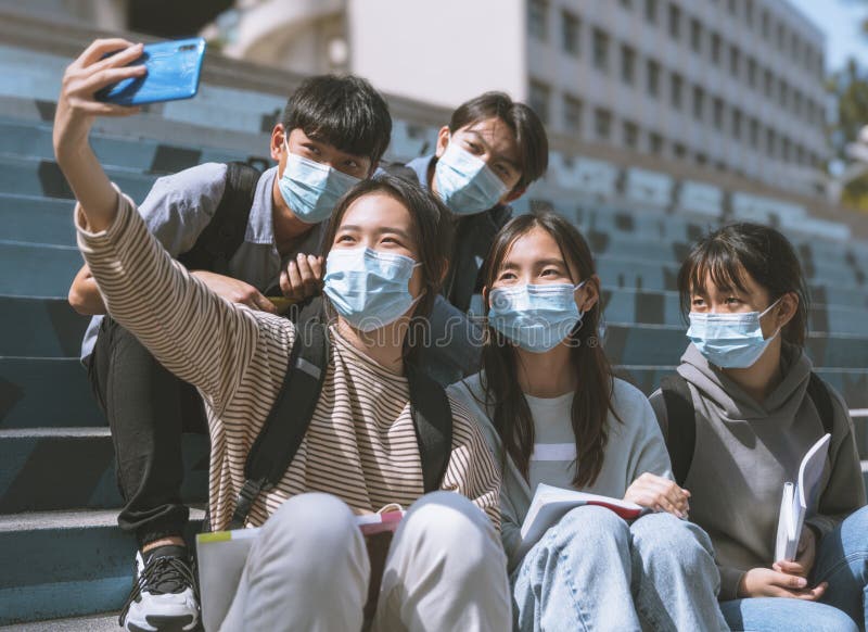 Young students wearing with face masks and taking selfie. Young students wearing with face masks and taking selfie.