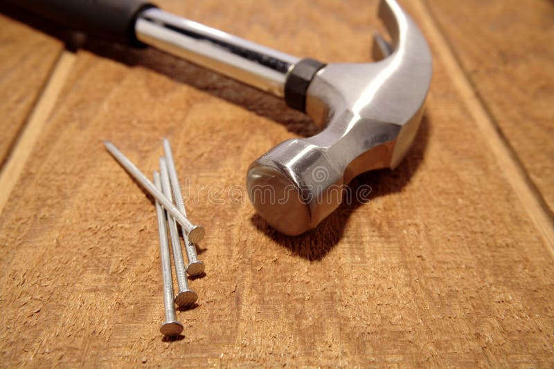 Hammer and nails on wooden panel. Hammer and nails on wooden panel