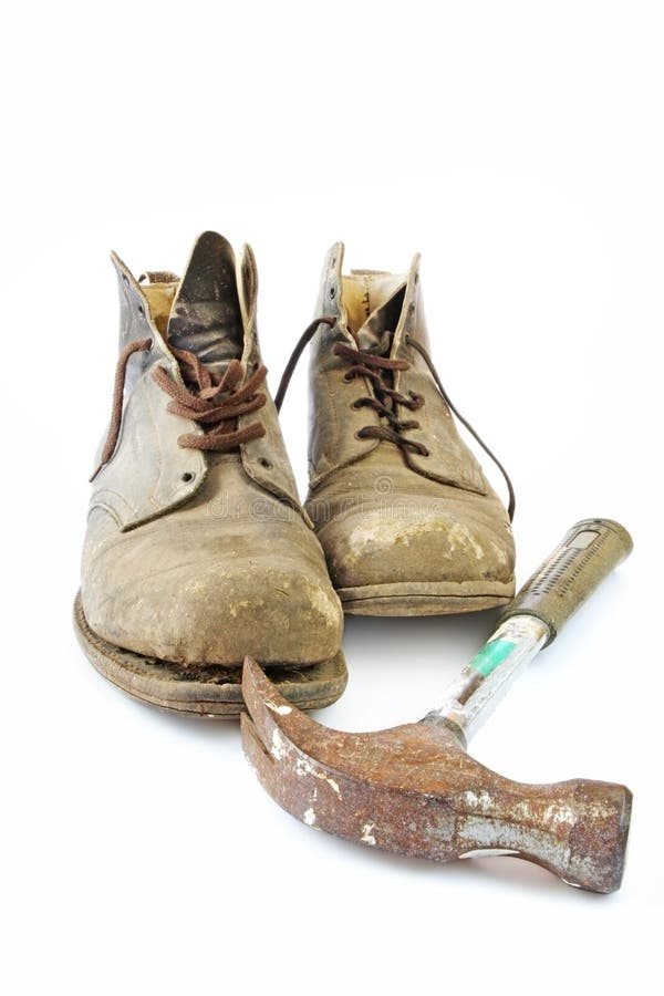 Vintage workboots with rusted hammer, isolated on white. The boots are 1940's vintage, and have been well-worn until recenty. Vintage workboots with rusted hammer, isolated on white. The boots are 1940's vintage, and have been well-worn until recenty.