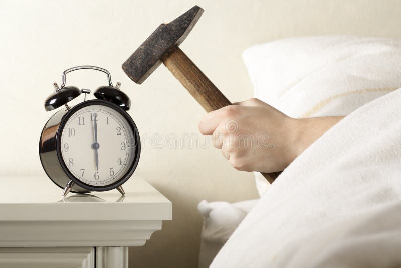 Hand with Hammer Smashing Alarm Clock from the Bed. Hand with Hammer Smashing Alarm Clock from the Bed