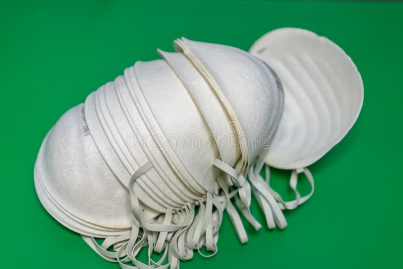 N95 Face Masks on a Green Background. Multiple Stocks of N95 Face Masks