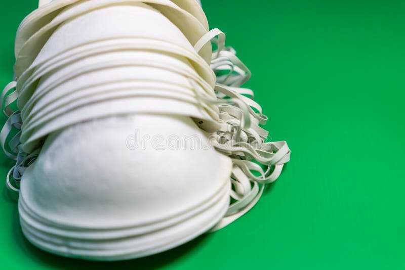 N95 Face Masks on a Green Background. Multiple Stocks of N95 Face Masks