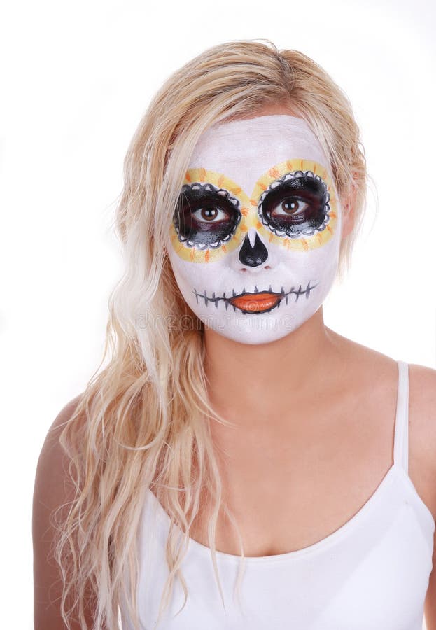 Skull makeup on blonde young girl isolated on white, Halloween costume, day of the dead mask. Skull makeup on blonde young girl isolated on white, Halloween costume, day of the dead mask