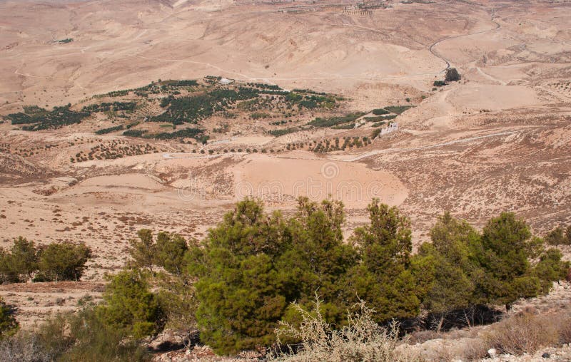 Jordan 05/10/2013: Jordanian and desert landscape with the winding road to Mount Nebo, an elevated ridge mentioned in the Hebrew Bible as the place where Moses was granted a view of the Promised Land. Jordan 05/10/2013: Jordanian and desert landscape with the winding road to Mount Nebo, an elevated ridge mentioned in the Hebrew Bible as the place where Moses was granted a view of the Promised Land