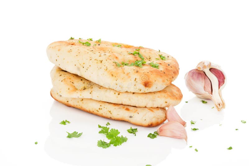 Garlic and coriander naan bread with fresh herbs and garlic on white background. Culinary eastern cuisine. Garlic and coriander naan bread with fresh herbs and garlic on white background. Culinary eastern cuisine.