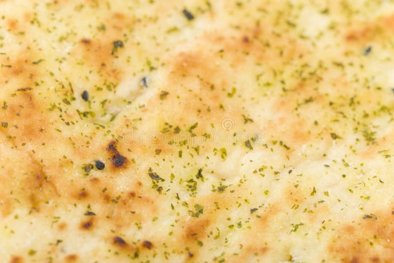 Naan Bread Background - Close up of a garlic and coriander flatbread.