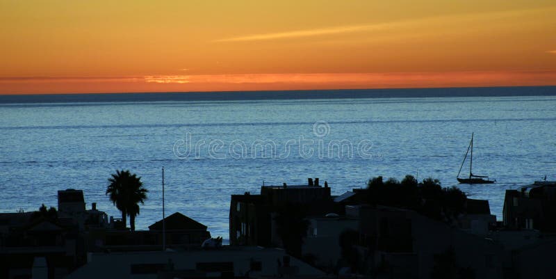 Sail boat returning to home port at sunset. Sail boat returning to home port at sunset