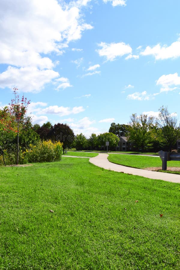 Neighborhood Sidewalk Winding Through a City Park on a Beautiful, Fall Day. Neighborhood Sidewalk Winding Through a City Park on a Beautiful, Fall Day