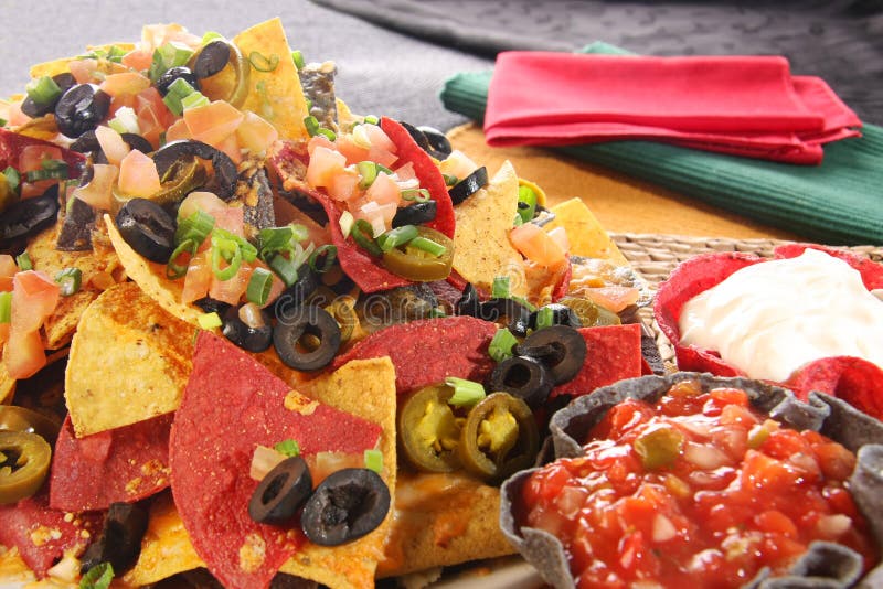 Nachos with cheese, salsa and sour cream. Nachos with cheese, salsa and sour cream.