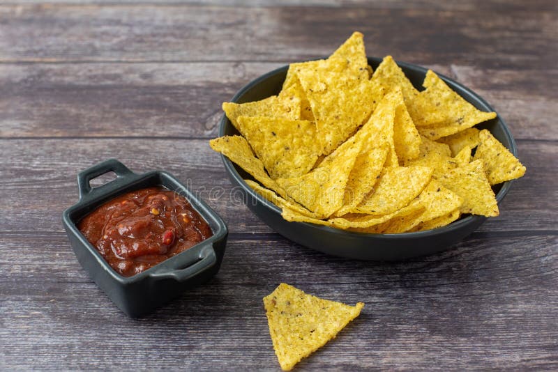 Nachos Corn Chips with Fresh Homemade Salsa on Wooden Table Stock Photo