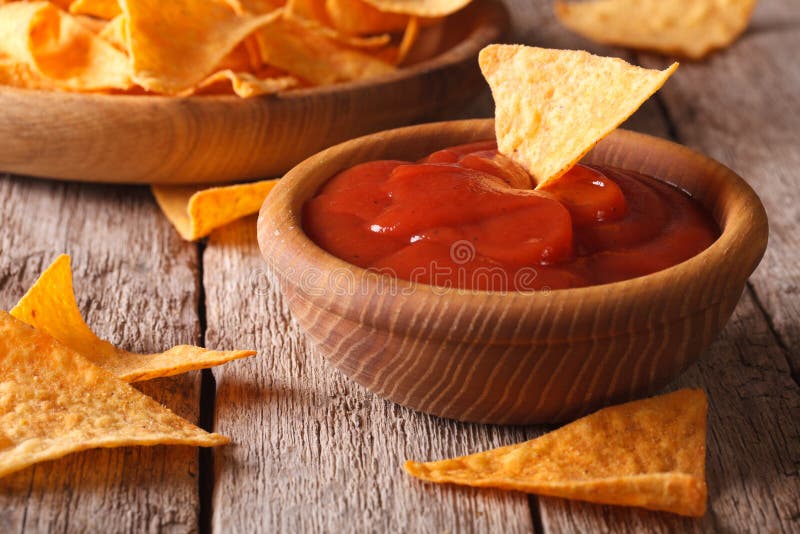 Nachos Corn Chips with Spicy Sauce Closeup. Horizontal Stock Photo