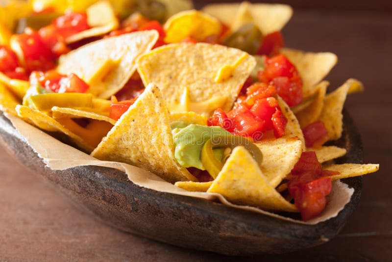 Nachos Loaded With Salsa, Guacamole, Cheese And Jalapeno Stock Photo