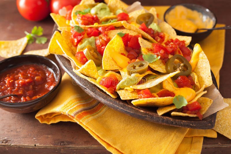 Nachos Loaded With Salsa, Guacamole, Cheese And Jalapeno Stock Image