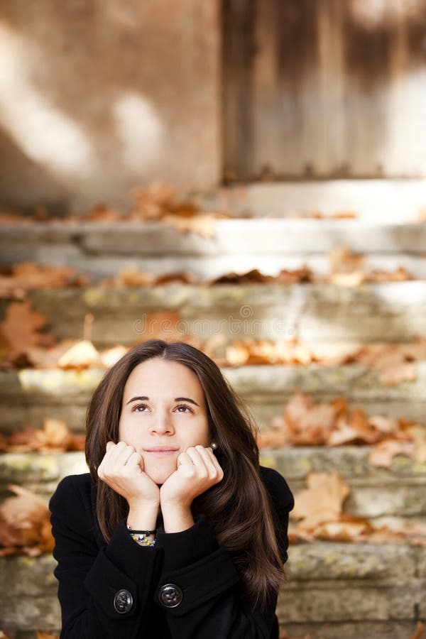 Young beautiful thoughtful girl in autumn background. Young beautiful thoughtful girl in autumn background
