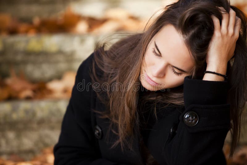 Young beautiful thoughtful girl in autumn background. Young beautiful thoughtful girl in autumn background