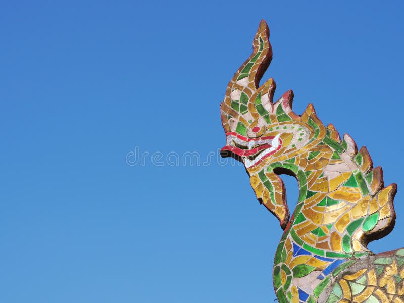 Naga or Serpent King statue with blue sky in buddhist temple royalty free stock photography