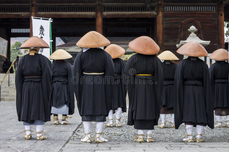 Buddhist monks looking at the Sanmon Gate in Zenko-ji, a buddhist temple located in Nagano, Japan. Buddhist monks looking at the Sanmon Gate in Zenko-ji, a buddhist temple located in Nagano, Japan