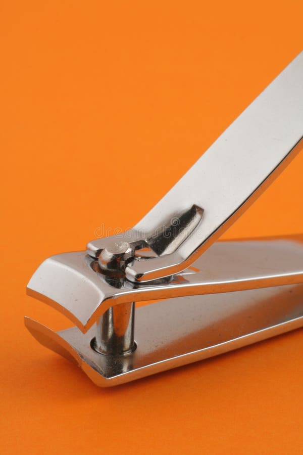 Nagelklipper auf Orange stockbilder Nagelklipper auf Orange stockbilder