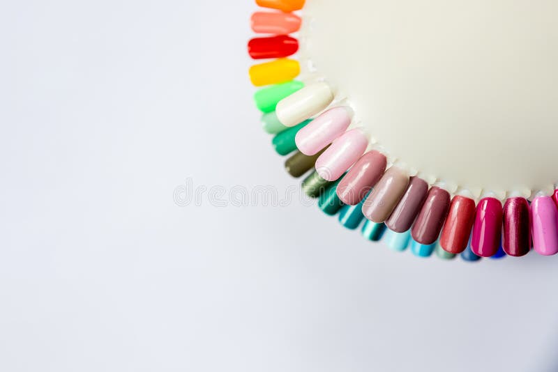 Nail polish in different fashion color. Colorful cats eye 3D nail lacquer in tips and mock-up blank bottle isolated white background. Nail polish in different fashion color. Colorful cats eye 3D nail lacquer in tips and mock-up blank bottle isolated white background.