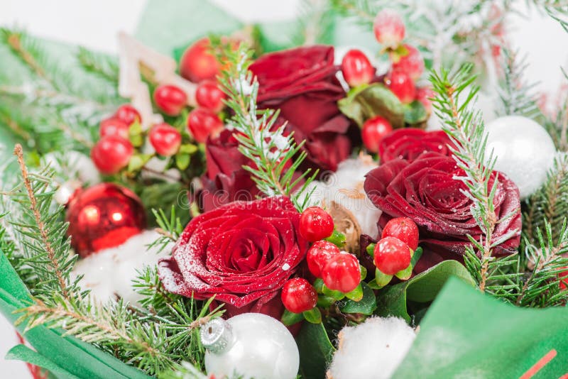 Close-up of Christmas bouquet with flowers and spruce with snow. shallow DOF. Close-up of Christmas bouquet with flowers and spruce with snow. shallow DOF