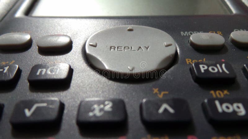 Closeup of Replay button of Casio FX-82MS Non-Programmable Scientific Calculator. black color calculator with grey color replay button. Closeup of Replay button of Casio FX-82MS Non-Programmable Scientific Calculator. black color calculator with grey color replay button.