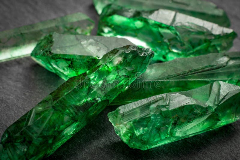 Closeup of a bunch of many green rough uncut emeralds. Closeup of a bunch of many green rough uncut emeralds
