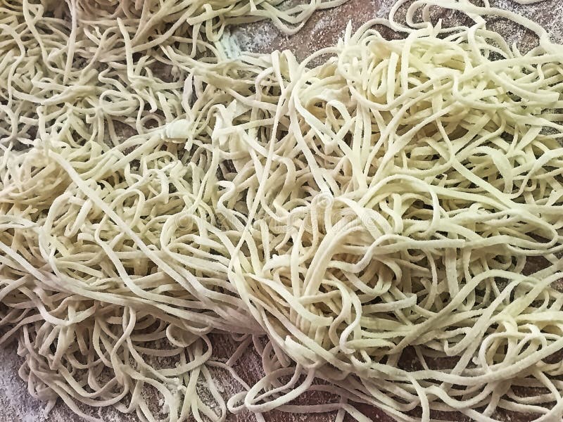 Nahaufnahme von bemehlten Winkelhaarteigwaren auf einem Schneidebrett lizenzfreie stockfotos Nahaufnahme von bemehlten Winkelhaarteigwaren auf einem Schneidebrett lizenzfreie stockfotos