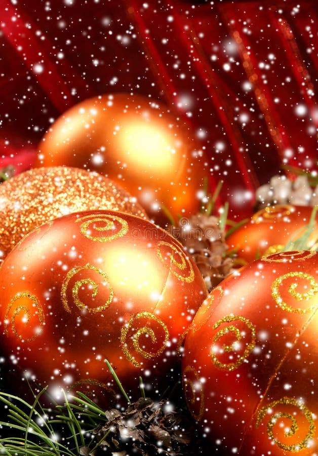 Close-up image of beautiful orange Christams balls and spruce needles. The image is taken on a light snowy background. Close-up image of beautiful orange Christams balls and spruce needles. The image is taken on a light snowy background.