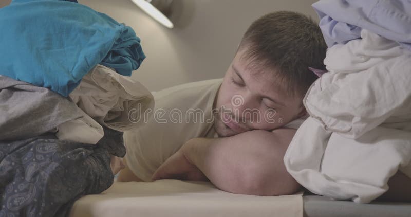 Nahaufnahmegesicht des erschöpften schlafenden kaukasischen Mannes Porträt der müden jungen männlichen Reinigungskraft zwischen S