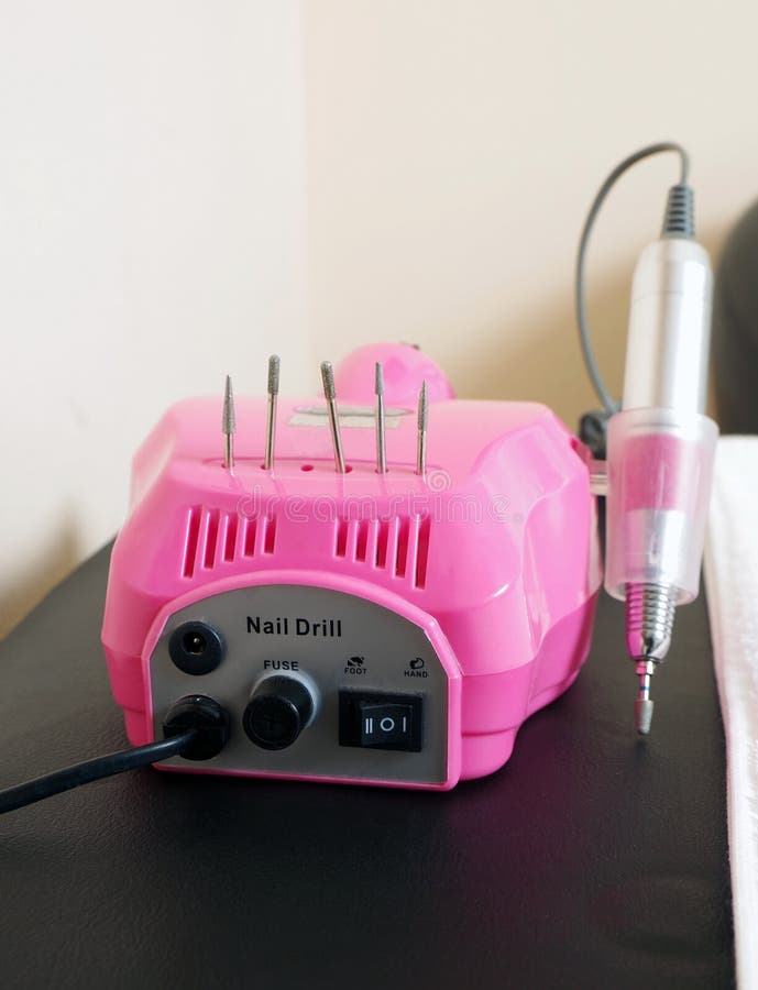 Nail Drill Machine Pen In Women Hand On Coral Background. Hardware