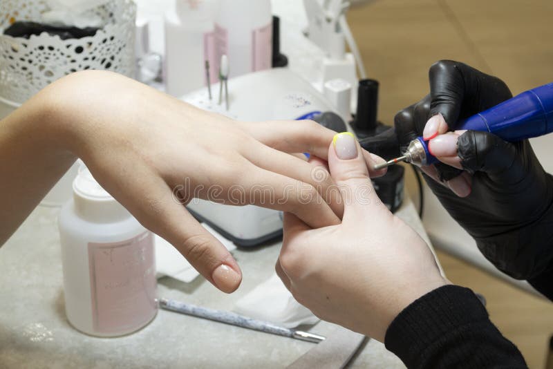 Nails Polish Procedure. Professional Hardware Manicure Using an