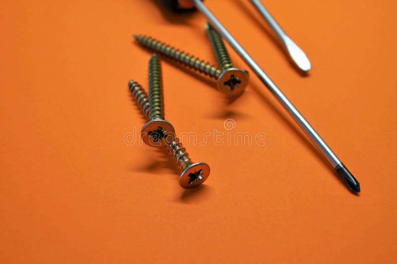 Nails and screwdrivers repair tools for home construction orange background royalty free stock photography Nails and screwdrivers repair tools for home construction orange background royalty free stock photography