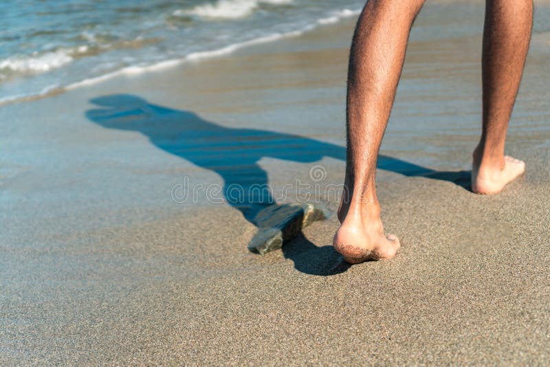 Topless ladies surrounded by dressed men at the beach