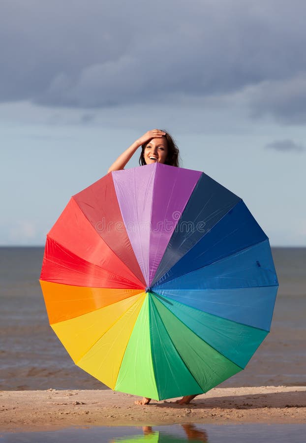 Naked girl with a colorful umbrella